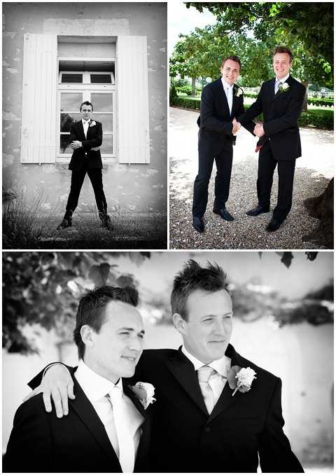A collage of three portrait-style photographs featuring the groom and a groomsman or best man taken outdoors at what appears to be a French estate or chateau. Top left is a black-and-white full-length portrait of a man in a dark suit with a white boutonniere standing against a white-shuttered window on a weathered building exterior; the image has strong contrast with deep shadows. Top right is a color portrait of two men in dark suits with light ties and white/green boutonnieres shaking hands and smiling on a gravel path surrounded by manicured hedges and trees. Bottom is a black-and-white close-up portrait of the same two men with their arms around each other's shoulders, both wearing dark suits, light ties, and white floral boutonnieres, with soft tonal contrast and a blurred outdoor background.