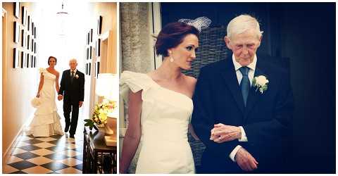 A composite of two images showing a bride walking with an older gentleman, likely her father, in what appears to be a pre-ceremony escort moment. In the left image, the pair walk down a hallway with black-and-white checkered tile floors and framed artwork on white walls, photographed as a wide shot from the front. The bride wears a fitted asymmetric one-shoulder white gown with a mermaid silhouette and carries a small bouquet of yellow and white flowers; she has short dark hair with a small white hair accessory. In the right image, a closer portrait shot shows the same bride and gentleman pausing near a dark doorway, where he wears a dark navy suit with a white and green boutonniere. Both images have a slightly warm, vintage-toned processing style.