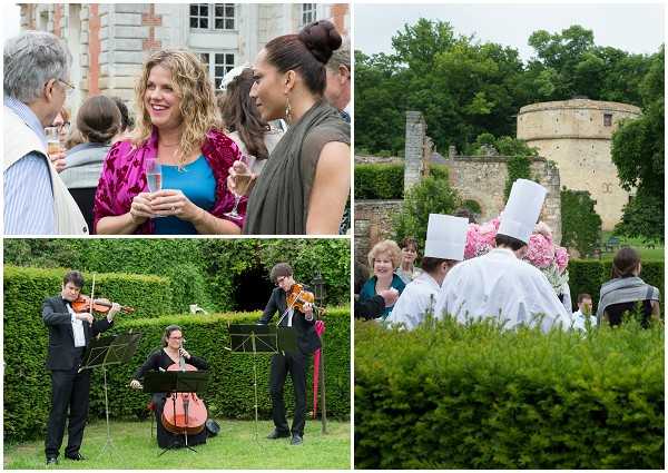 A collage of three images from an outdoor wedding cocktail hour at what appears to be a French chateau. Top left shows wedding guests mingling and holding champagne flutes, including a woman in a fuchsia velvet top and another in a grey-green dress, with the chateau's brick facade visible in the background. Bottom left shows a string trio — two violinists and a cellist — performing on a lawn bordered by tall hedges, all dressed in black formal attire with music stands in front of them. Right image shows guests seated outdoors near stone ruins of a tower, with chefs in white uniforms and tall toques visible among the crowd, and pink floral arrangements providing color accents. The overall style is classic and formal, with live music and catered service as key event features. Potential venue feature image.