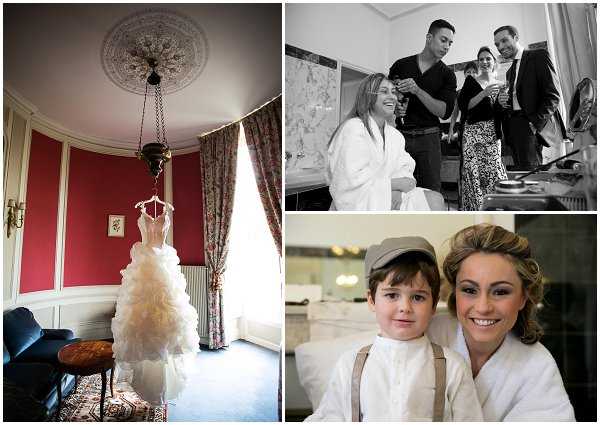 A triptych of getting-ready images. Left panel: a wide interior shot of a formal room with deep red walls, ornate plaster ceiling medallion, and tall draped windows, where an ivory ruffled ballgown wedding dress hangs from the ceiling light fixture. Top right panel: a black-and-white image of the bride seated in a white robe having her hair styled by two attendants, with makeup and styling tools visible on the counter in the background. Bottom right panel: a close-up portrait of the bride in a white robe with fully styled hair and makeup, posing alongside a young boy dressed in a white shirt, suspenders, and a flat cap, both smiling at the camera.