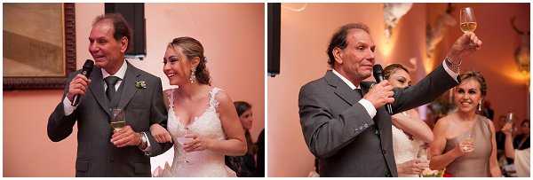 A two-panel image capturing a wedding reception speech and toast indoors. In the left panel, a man in a dark gray suit with a green tie holds a microphone and stands beside the bride, who wears a lace V-neck wedding gown and holds a champagne glass; both are laughing and appear to be mid-speech. In the right panel, the same man raises a champagne glass high in a toast gesture while speaking into a microphone, with the bride visible in the background also holding a glass and smiling. The setting is a warmly lit interior reception room with amber-toned walls, suggesting a classic or traditional ballroom or chateau venue. Both panels are medium-wide portrait shots taken in a candid documentary style.