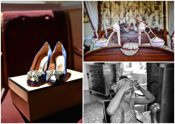 A collage of three getting-ready detail and portrait shots. Top left: a close-up of dark navy blue open-toe heels with embellished floral crystal embellishments, displayed on their shoe box in a warmly lit interior setting. Top right: a pair of ivory or champagne satin platform heels with ankle straps displayed on the footboard of a dark wood bed frame in a classically furnished bedroom with floral curtains visible in the background. Bottom right: a black-and-white portrait of a woman, likely a bridesmaid or the bride, adjusting her hair or headpiece with both hands raised; she is seated in a chair in an ornately furnished interior room, wearing a floral or patterned top, with soft contrast and mid tones throughout the image.