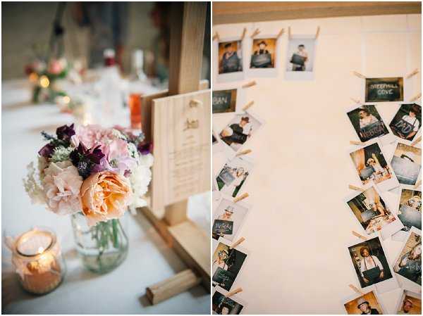 A split image showing two reception decor details. On the left, a close-up of a table centerpiece featuring a mason jar filled with peach garden roses, blush peonies, white hydrangeas, and deep purple anemones, accompanied by a lit votive candle in an amber glass holder and a wooden table number or menu sign on a small easel. On the right, a seating chart or guest display board covered in Polaroid-style photos clipped with wooden clothespins, with small chalkboard name labels identifying guests or tables; the photos are arranged in diagonal lines across a white board surface. The overall decor palette is warm and romantic with a rustic-bohemian style using natural wood elements and mixed blooms.