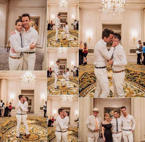 A collage of seven images documenting what appears to be a same-sex wedding or engagement celebration in an ornate indoor ballroom featuring crystal chandeliers, gold wall sconces, white paneled walls, oil paintings, and a richly patterned gold and green carpet. Both men wear white or off-white suits with dark belts — one with a navy tie and the other with a black tie — creating a coordinated look. The sequence of shots appears to capture a proposal or first dance moment, including one man kneeling on the floor while the other reacts, followed by the two embracing and kissing. Additional images show the couple sharing a close embrace and kiss, as well as a portrait with two older guests — a man in a tan suit and a woman in a black dress — likely family members. Guests in casual to semi-formal attire are visible in the background. The collage combines wide environmental shots and closer portrait-style compositions.
