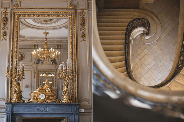 A two-image detail composite showcasing the interior architecture of a classical French venue. The left image shows a dark marble fireplace mantel topped with ornate gilded bronze candelabras and a gilt clock, reflected in a large gold-framed mirror with decorative molding; a crystal and brass chandelier is visible in the reflection against white and gold paneled walls. The right image is a top-down aerial shot of a curved stone staircase with an ornate wrought-iron handrail featuring scroll detailing, showing the spiral descent to a diamond-pattern stone floor below. Both shots are close-up architectural detail compositions highlighting the venue's classical French interior design with gold, cream, and stone tones. Potential venue feature image.