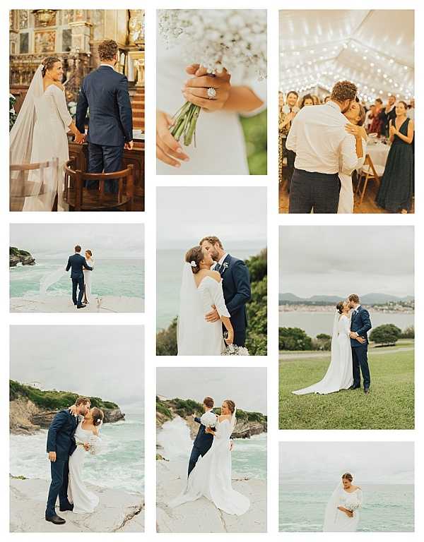 A nine-image collage from a coastal wedding, likely in the Basque Country region of France or Spain. Top row: the bride and groom stand at an ornate gilded altar inside a historic chapel, viewed from behind, with the bride wearing a long white gown with a cathedral-length veil; a close-up detail shot of the bride's hands holding a small bouquet of white baby's breath with a diamond solitaire ring visible; and a reception scene under a large white tent decorated with string fairy lights where the couple shares a first dance while guests in navy and dark formal attire look on. Middle and bottom rows: five outdoor couple portraits taken on rocky coastal cliffs and a grassy headland overlooking the ocean, with the groom in a navy suit and the bride in a long-sleeved white fitted gown with a flowing train and white floral hair accessory, carrying a small white baby's breath bouquet; poses include kissing, embracing, and walking together. The overall styling is clean and minimal with a coastal setting, navy and white color palette, and a classic-meets-relaxed feel.