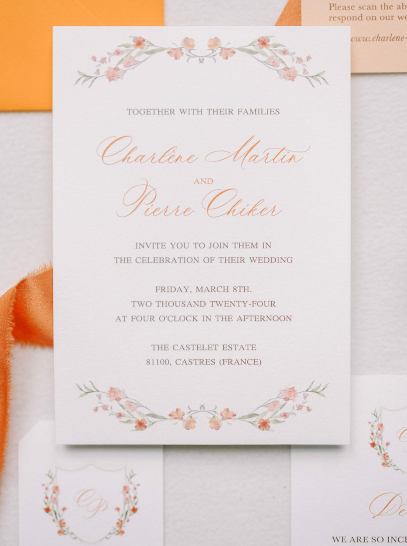 Terracotta calligraphy invitation suite with watercolor floral garland, vellum overlay, and silk ribbon