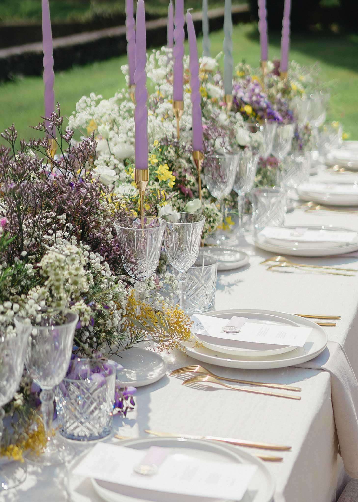 Garden table with meadow floral runner lavender twisted taper candles gold candlesticks and wax-sealed menus