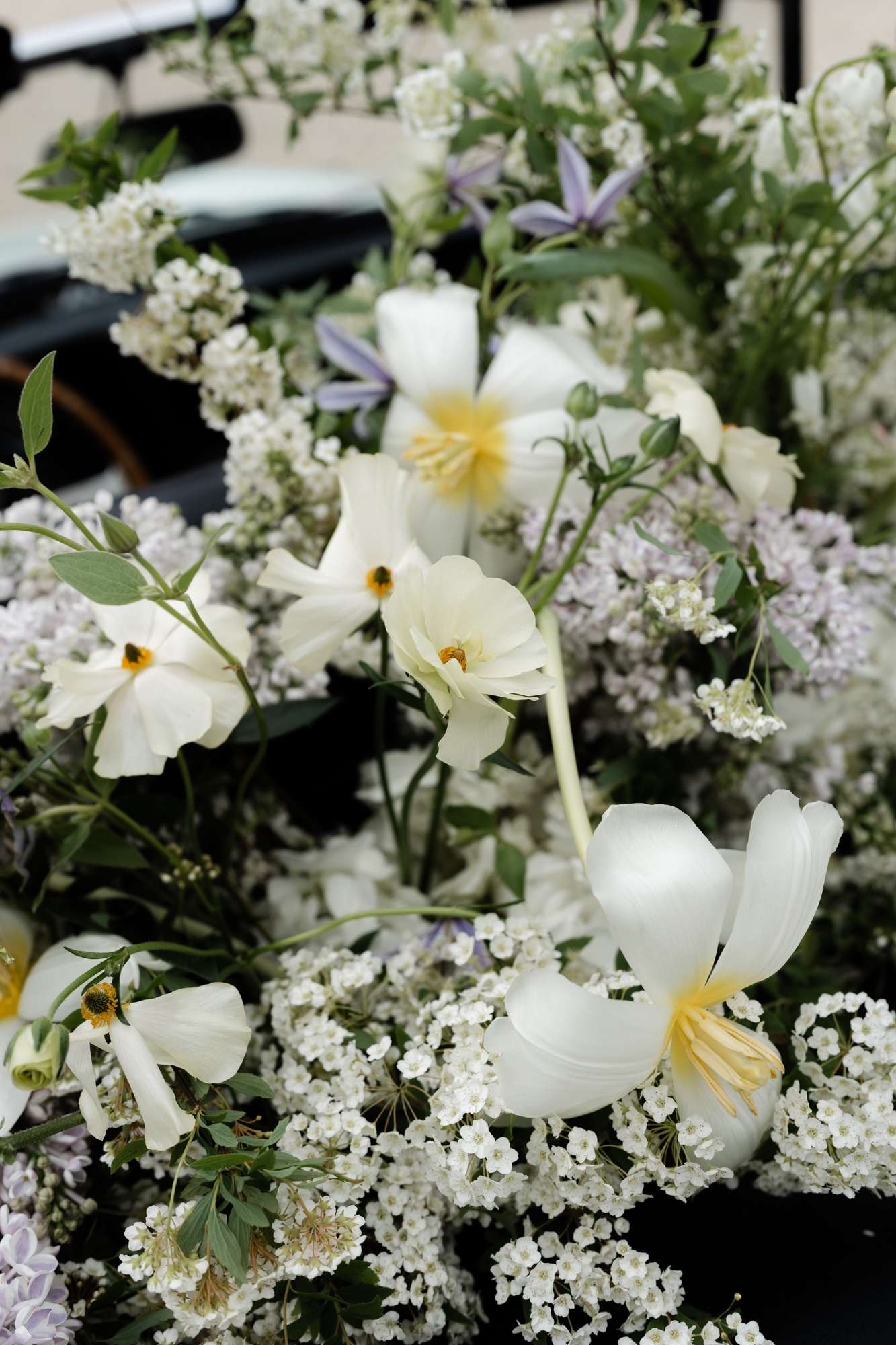 Bridal bouquet with white anemones, cream narcissus and baby's breath with lavender-blue flowers and green foliage