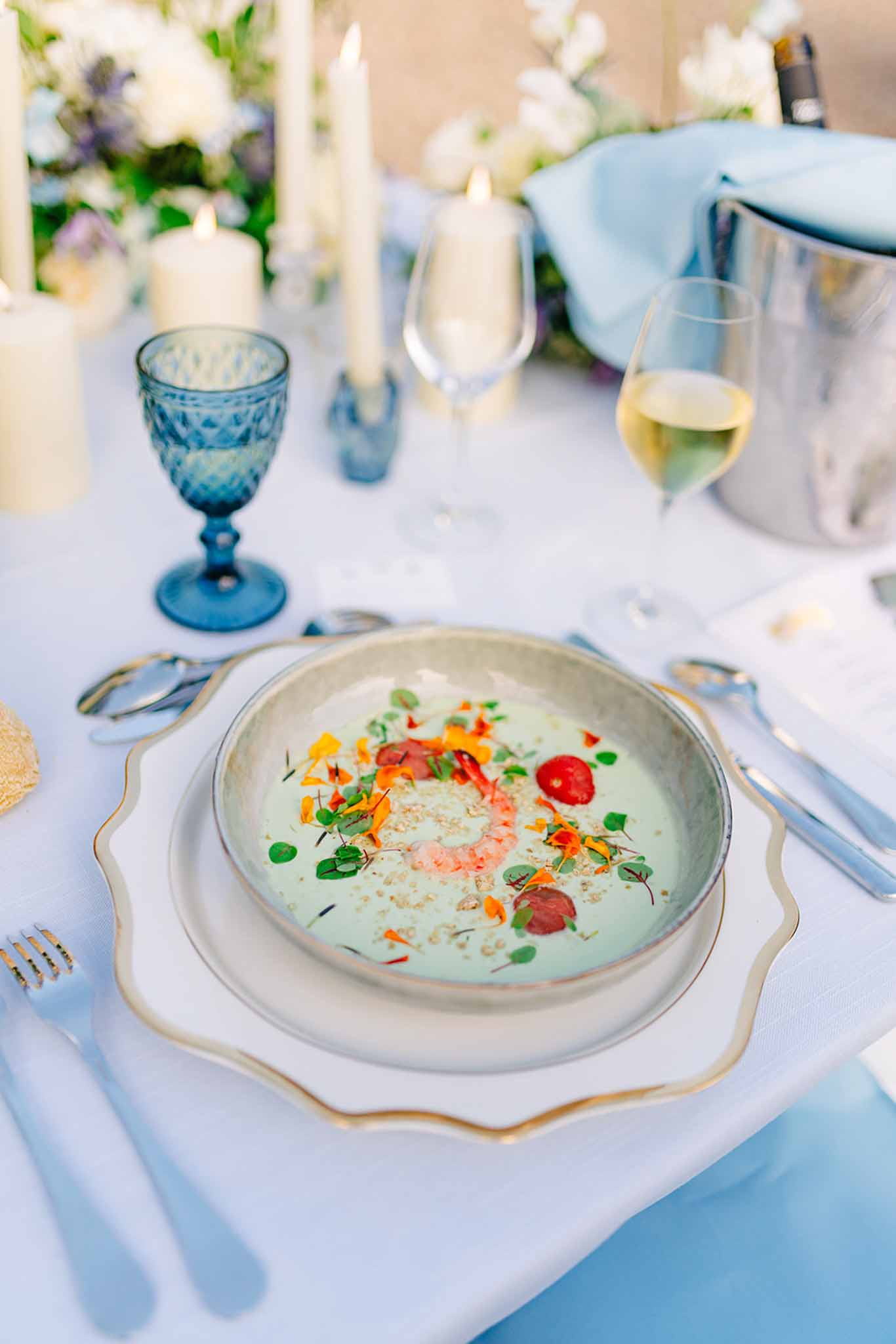 Close-up of a plated soup course at a formal wedding reception table
