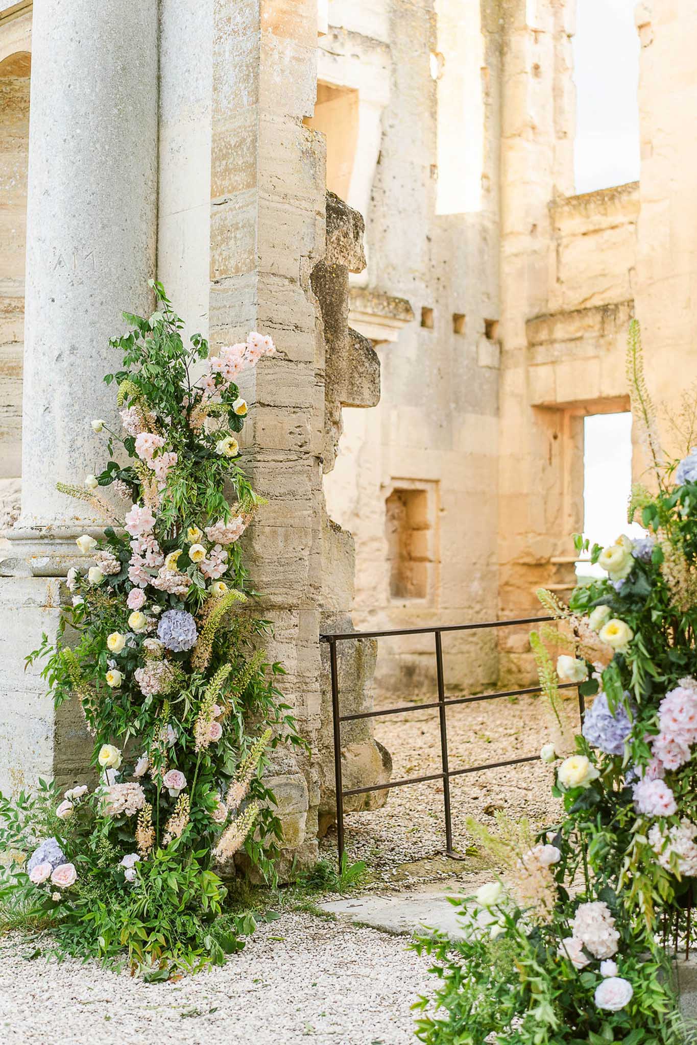 Wedding ceremony setup with floral decorations at a French chateau