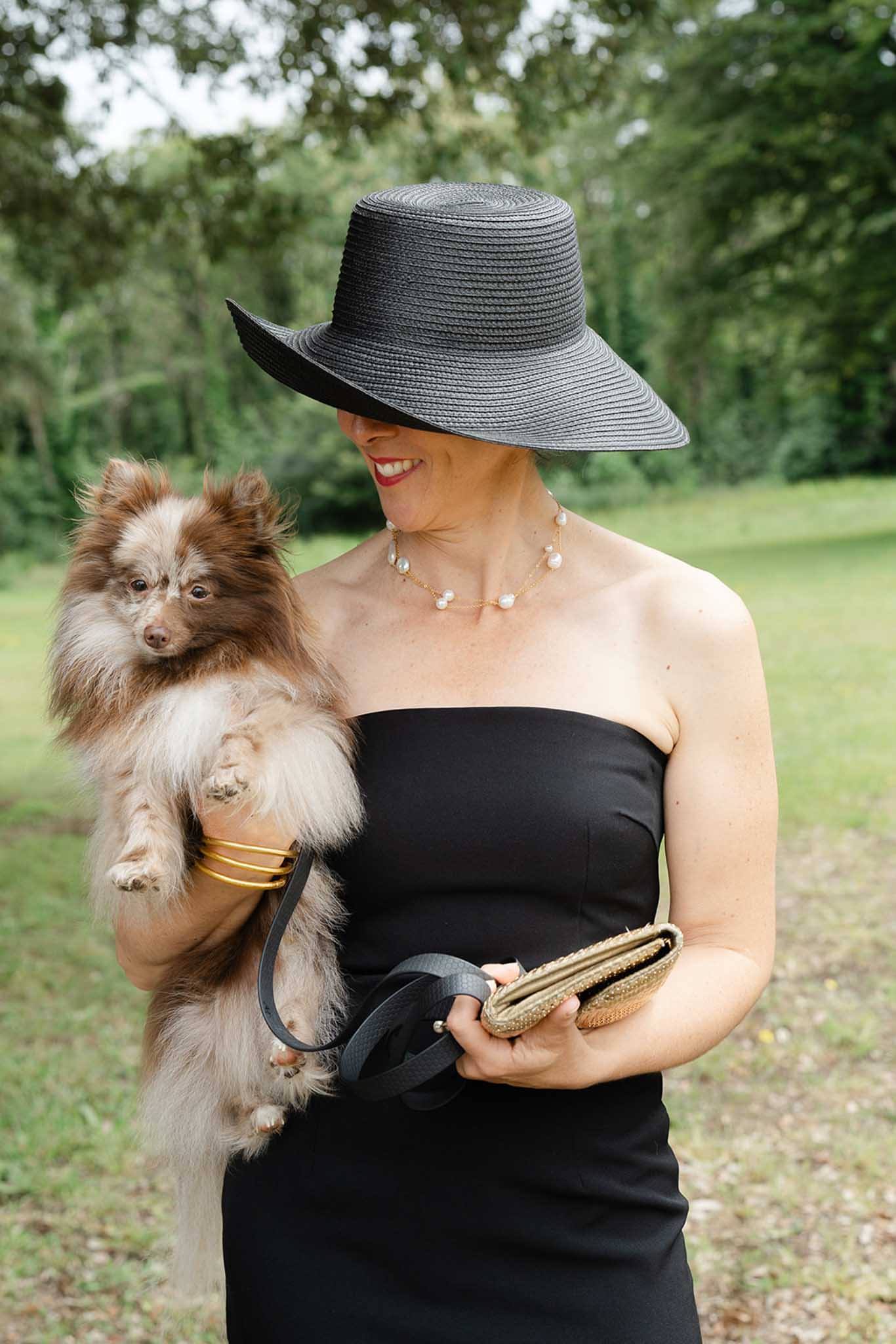Wedding guest posing for a portrait in a garden at a French venue