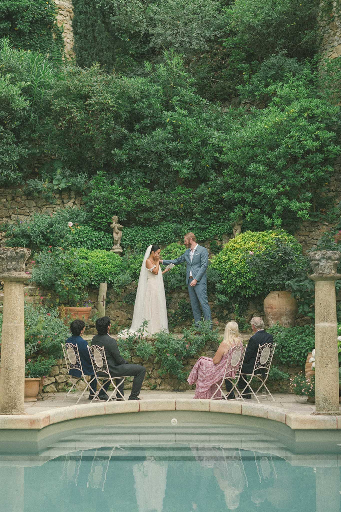 Intimate garden ceremony in Mediterranean courtyard with ivy-covered stone walls