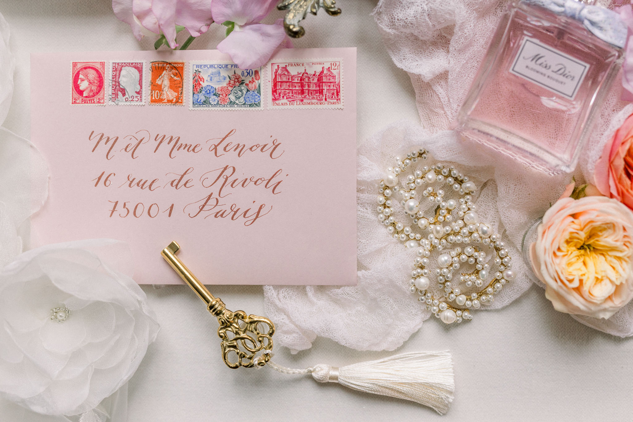Flat lay arrangement of wedding stationery and accessories
