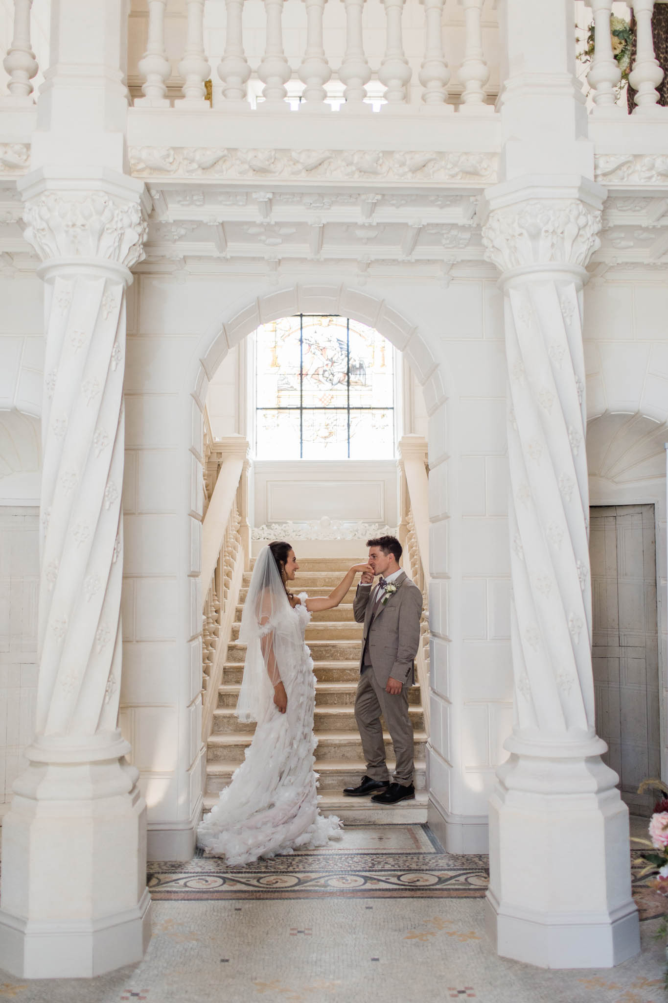 Couple on a staircase inside a French chateau