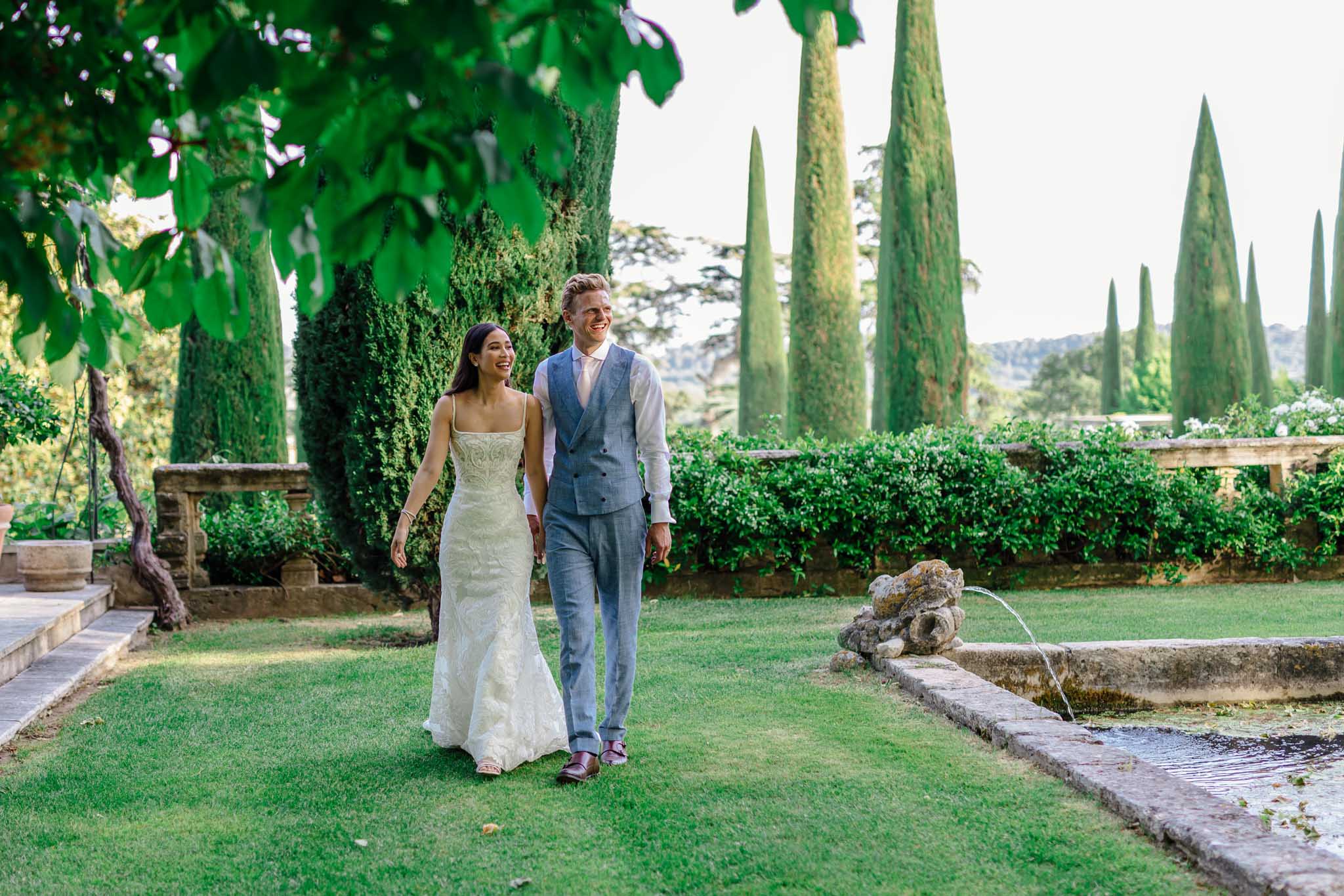 Outdoor reception table at Château de Sannes with white and green floral centerpieces and place settings