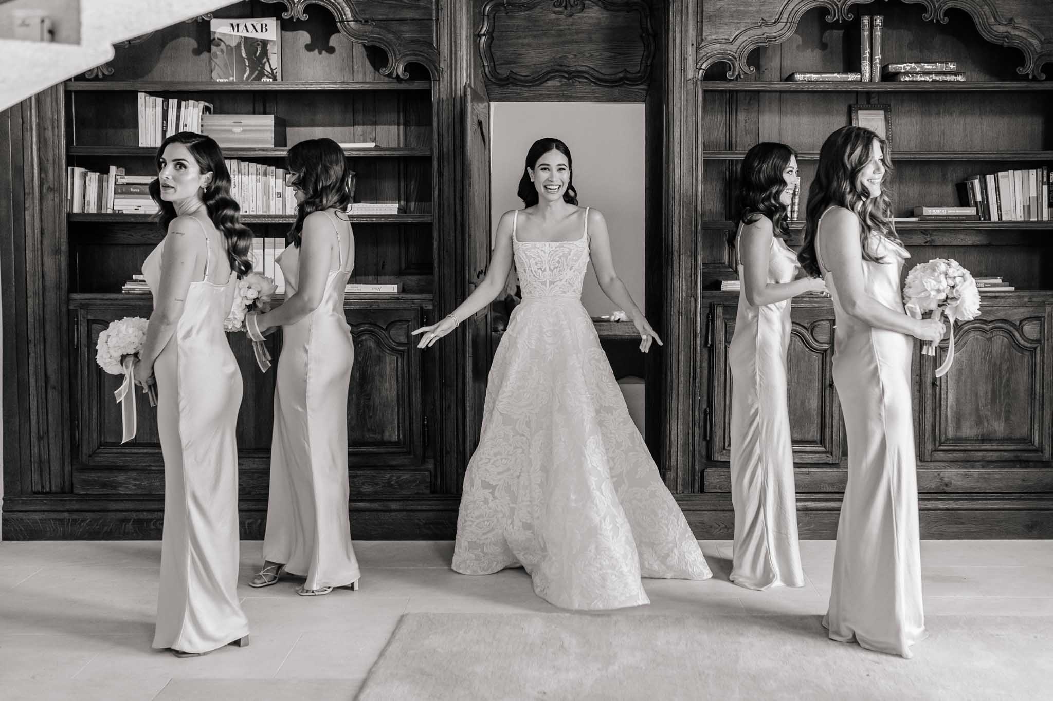 Black and white bridal party portrait with bride and four bridesmaids in ivory satin dresses