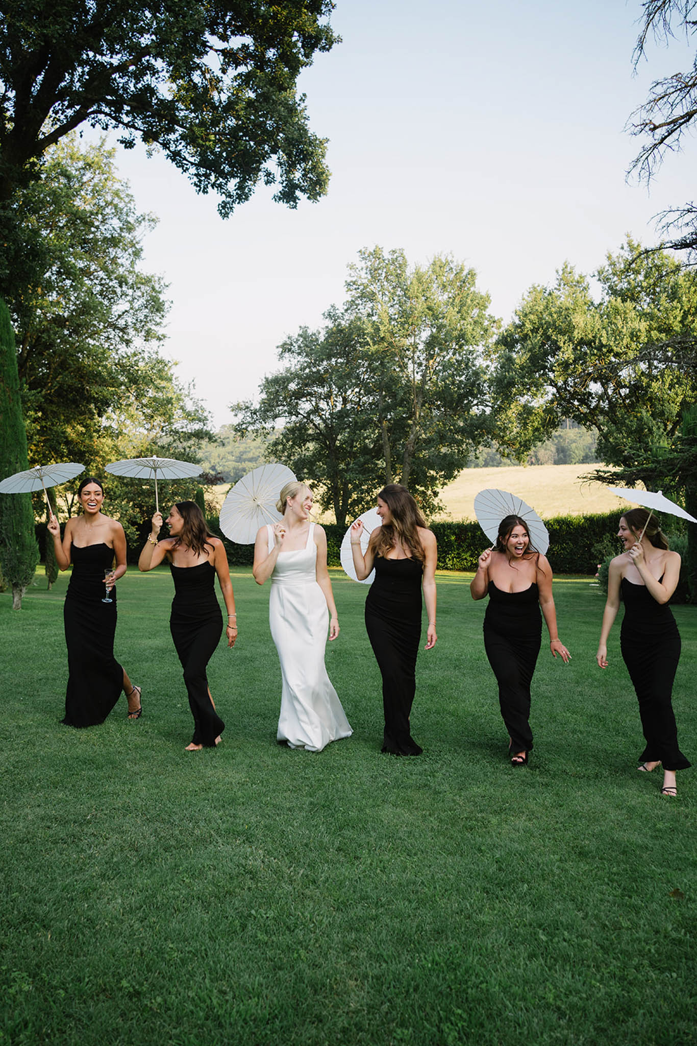 Outdoor ceremony at Château de Fontareches with floral arch and guests seated in garden