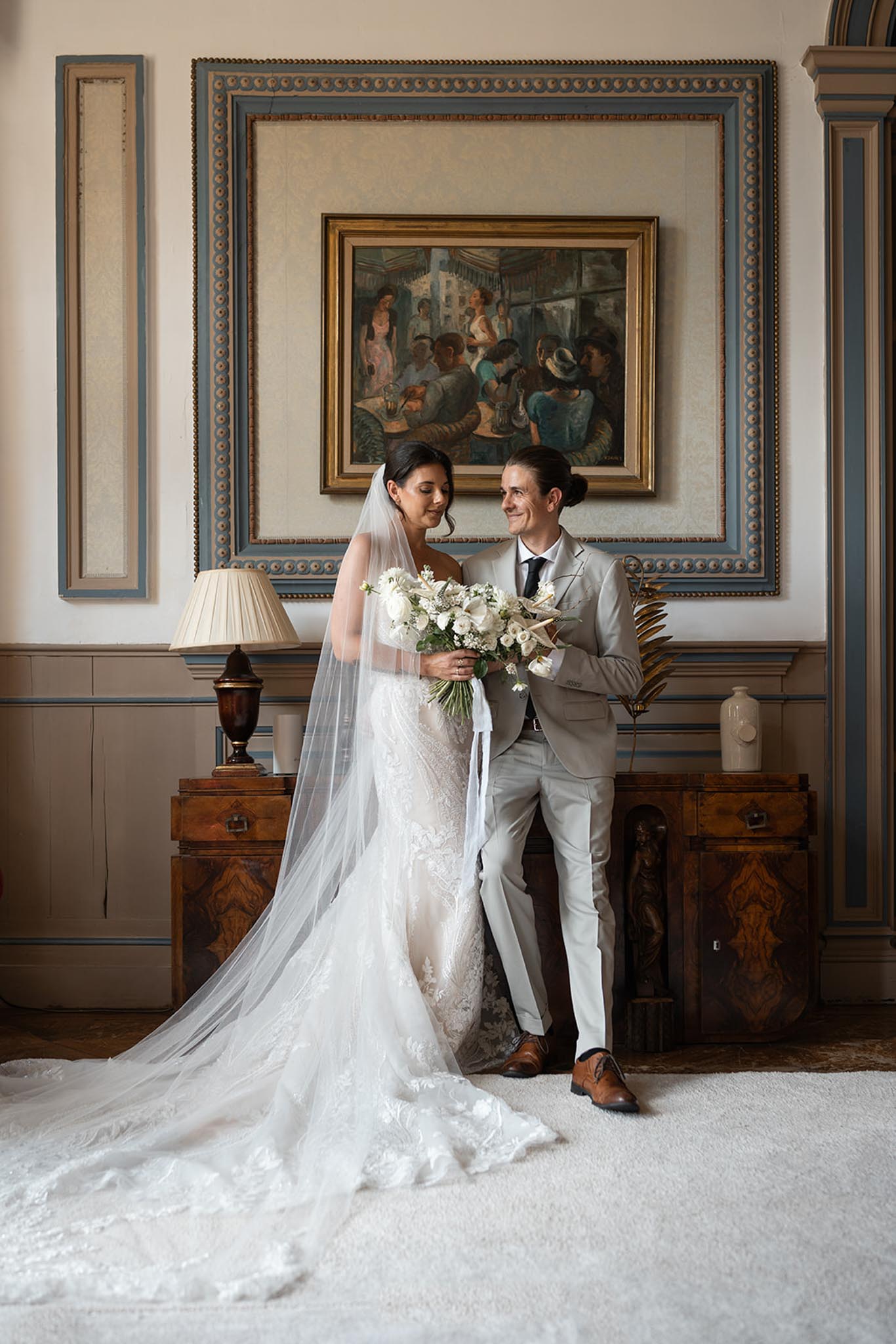 Bride and groom posing together inside a French chateau