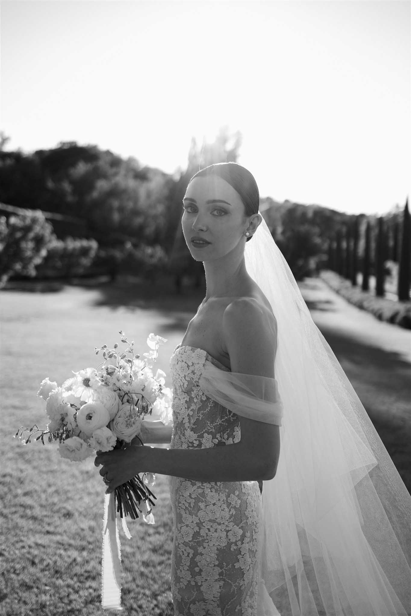 Bride in off-shoulder dress at Abbaye Saint-Eusèbe, black and white portrait photograph