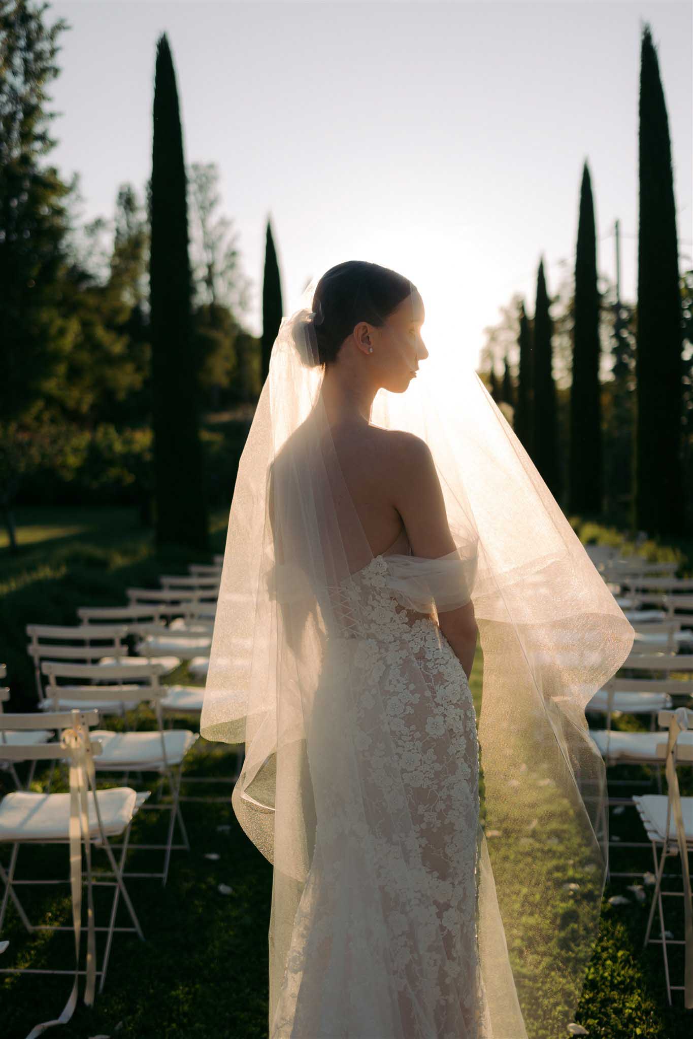 Bride in off-shoulder gown and veil photographed at sunset at Abbaye Saint-Eusèbe