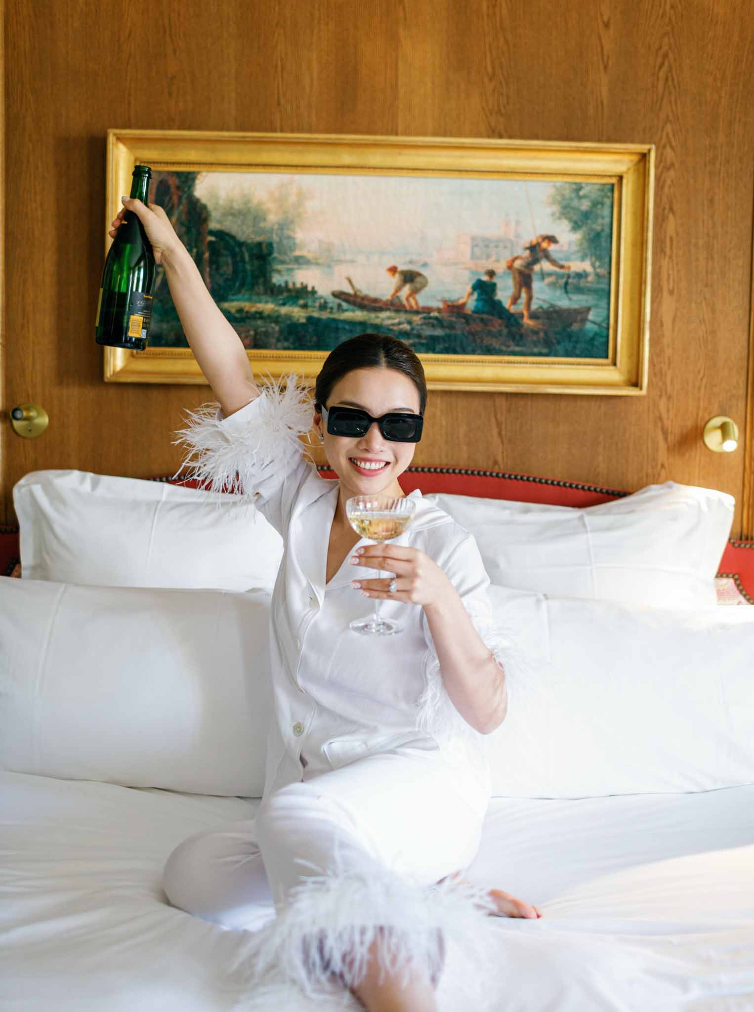 Bride celebrating with champagne in her suite before the ceremony