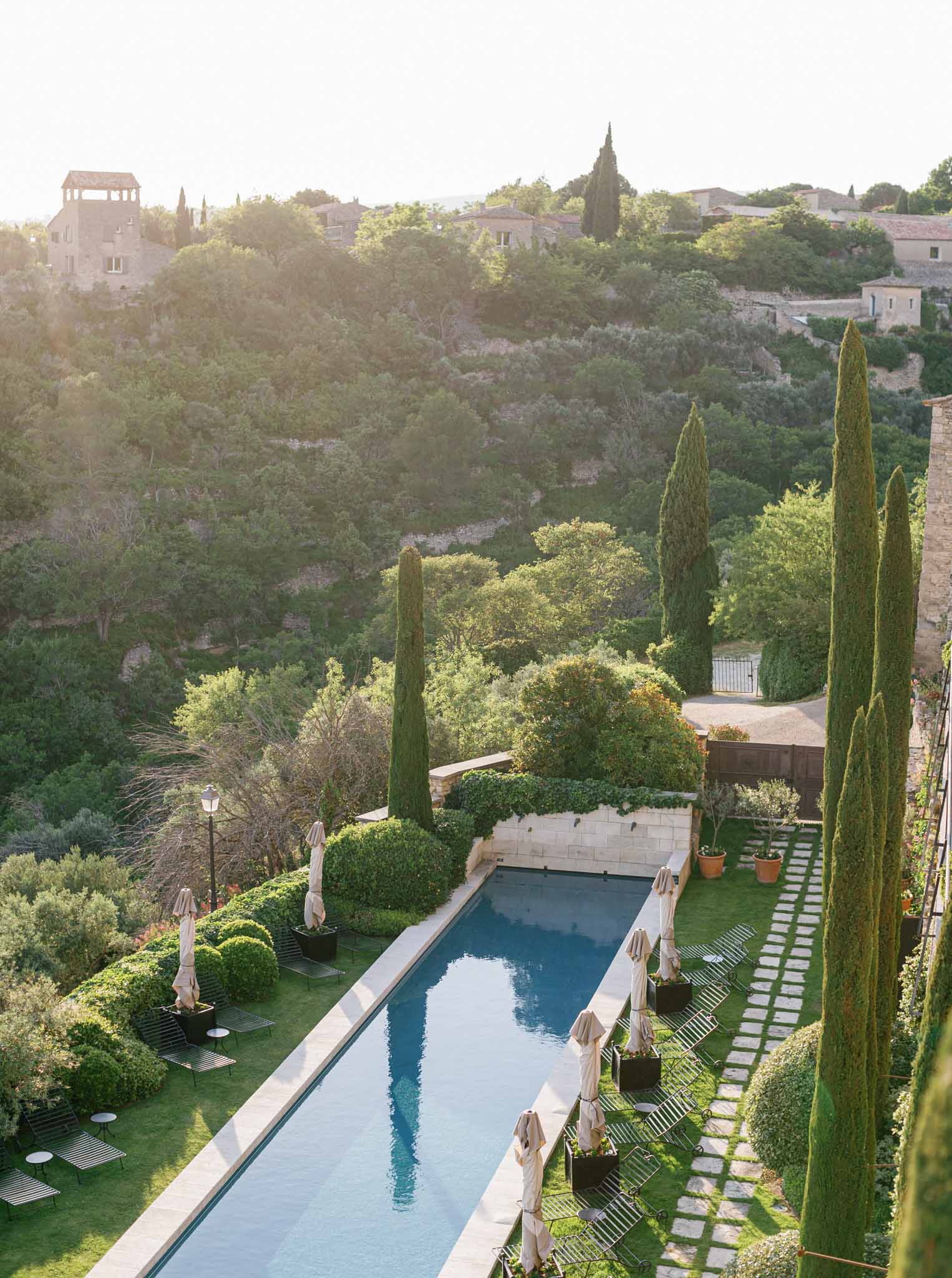 Aerial view of Mediterranean venue with rectangular pool, cypress trees, and manicured grounds