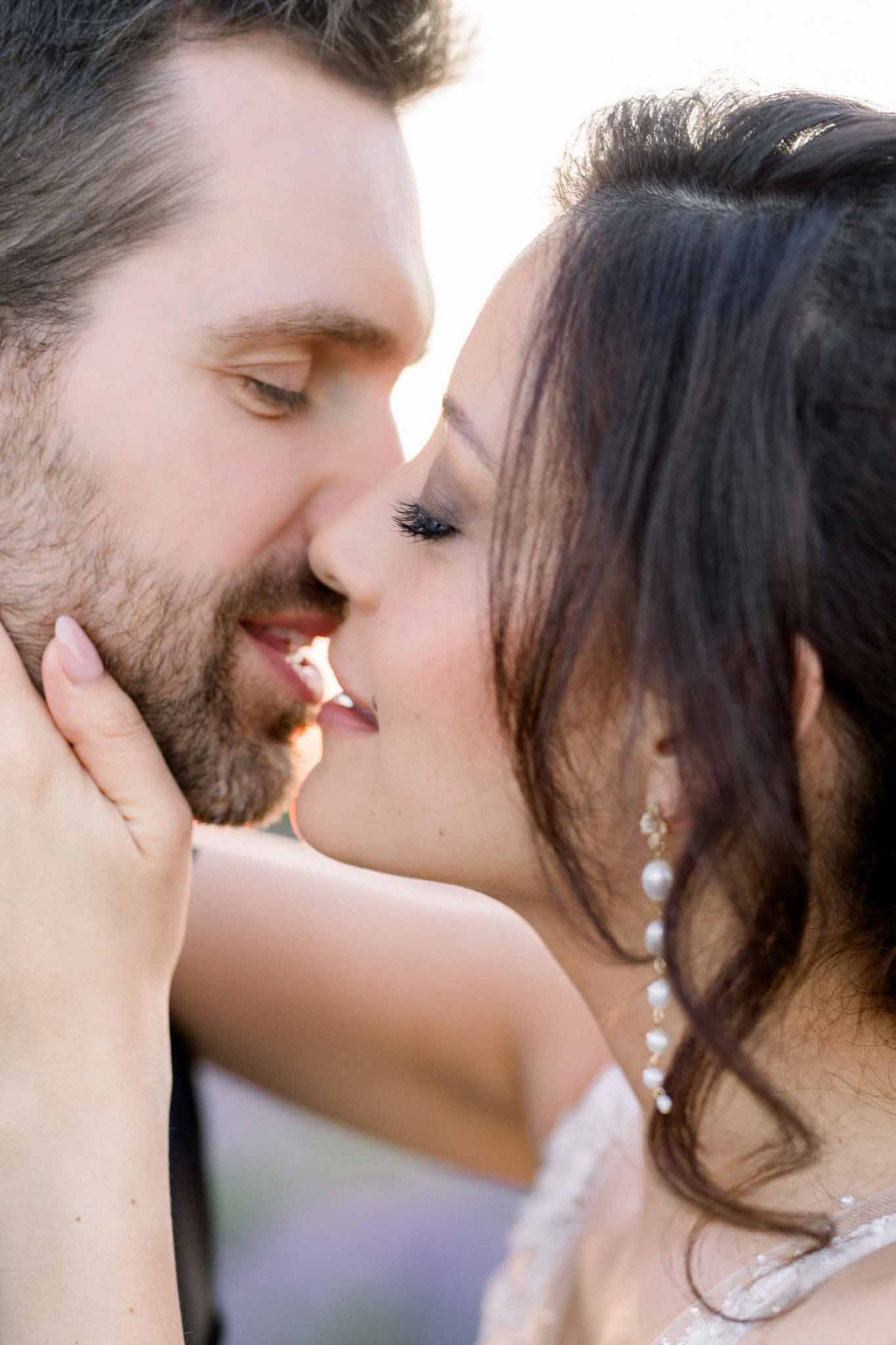 Bride and groom sharing a kiss outdoors