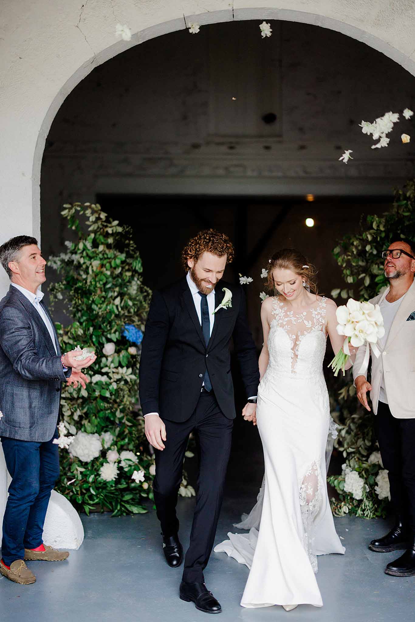 Bride and groom walking out of ceremony area together at Chateau Trieux photographed by M Mann