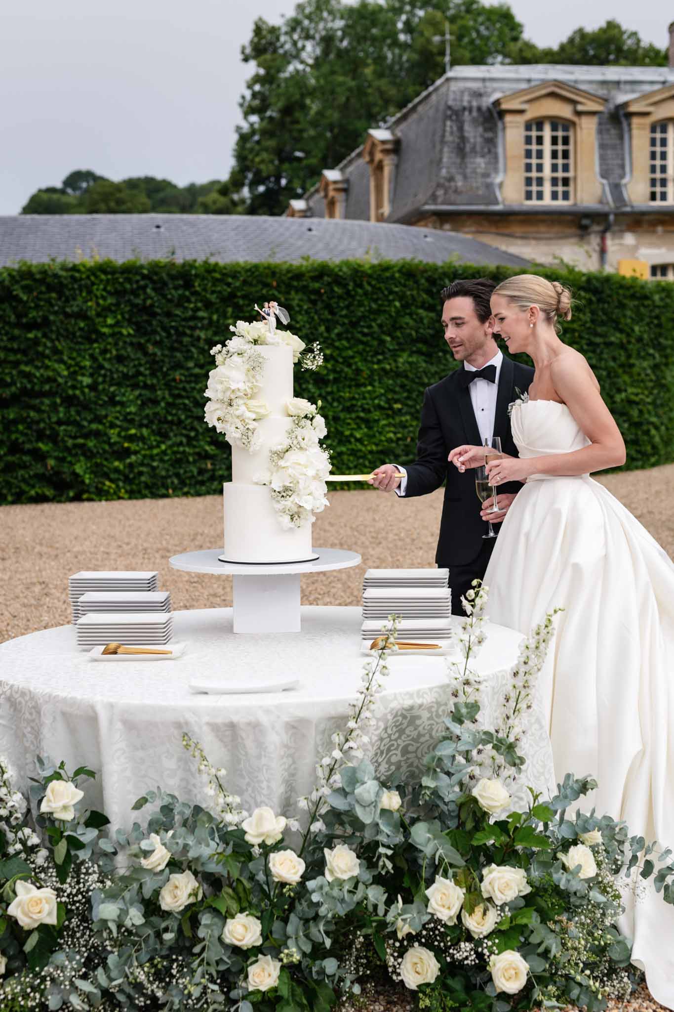 Bride and groom cutting their wedding cake at the reception