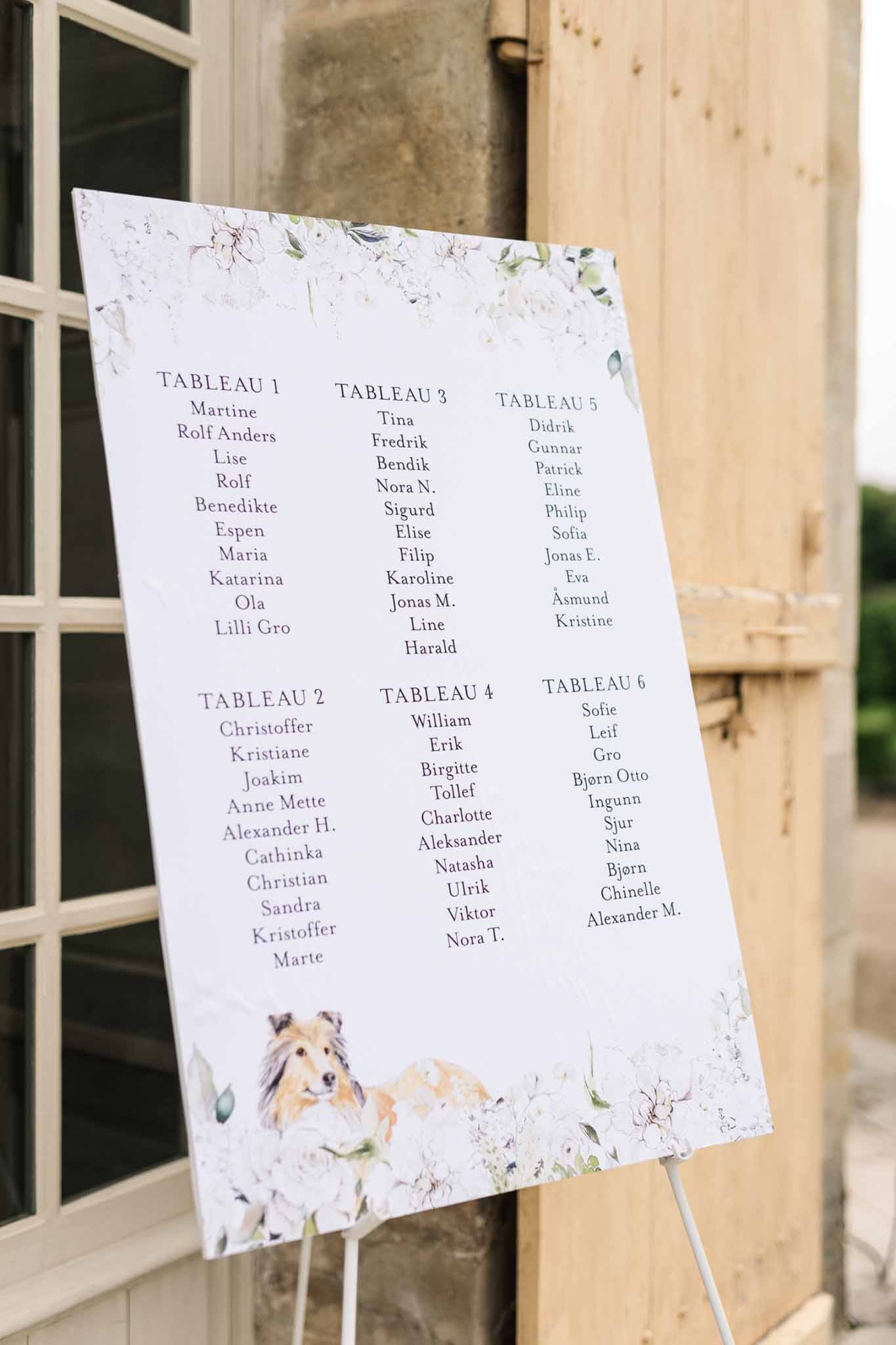 Seating chart with dog illustration and floral design at Château de Villette wedding