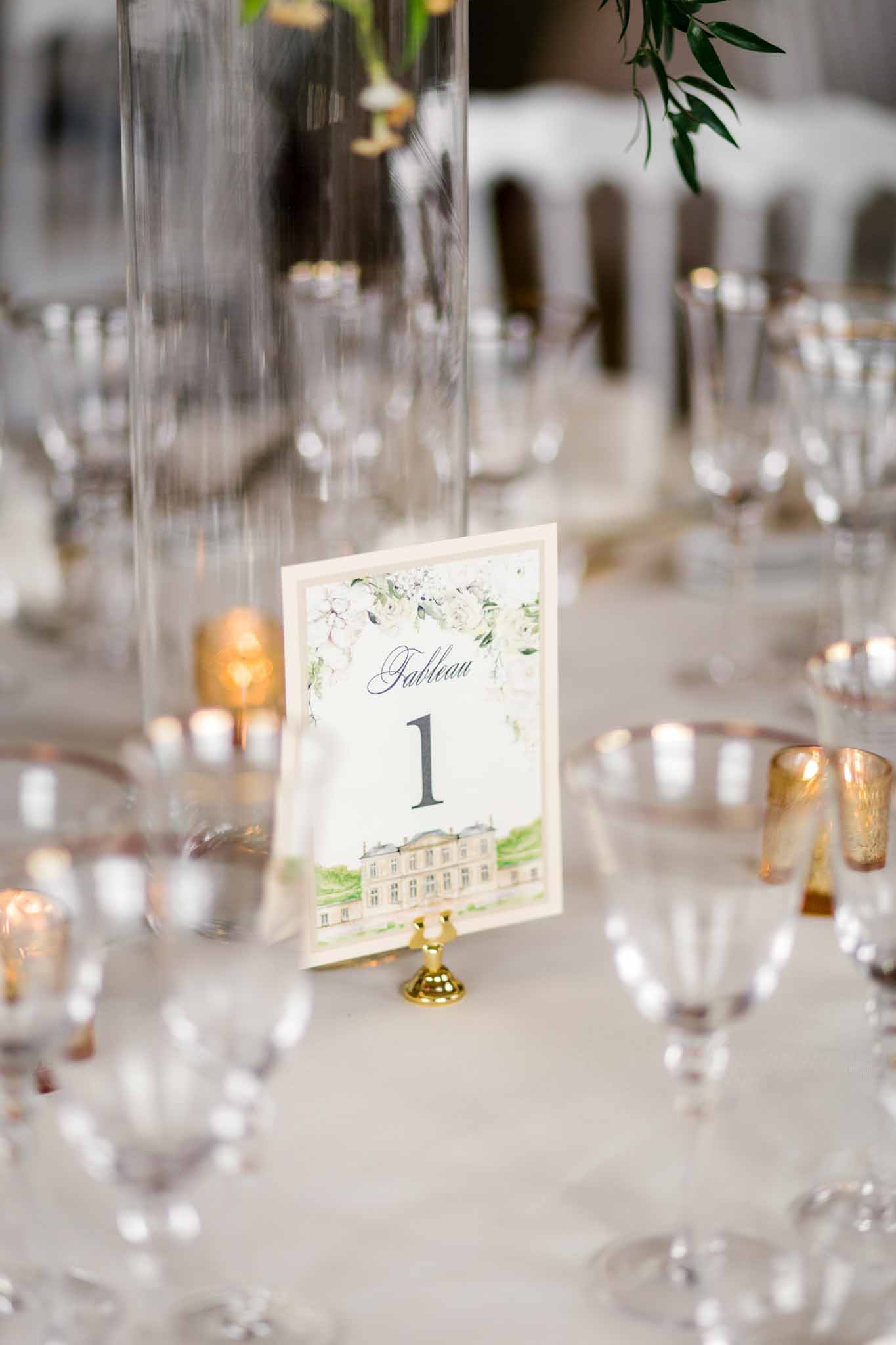 Small square table number card on white card with elegant typography at Château de Villette wedding