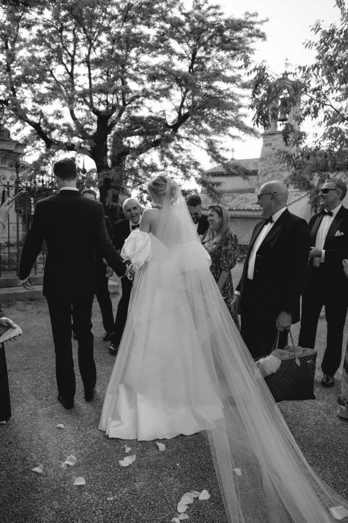 Bride and groom greeted by guests with black and white styling at Chateau de Martinay by Despinoy