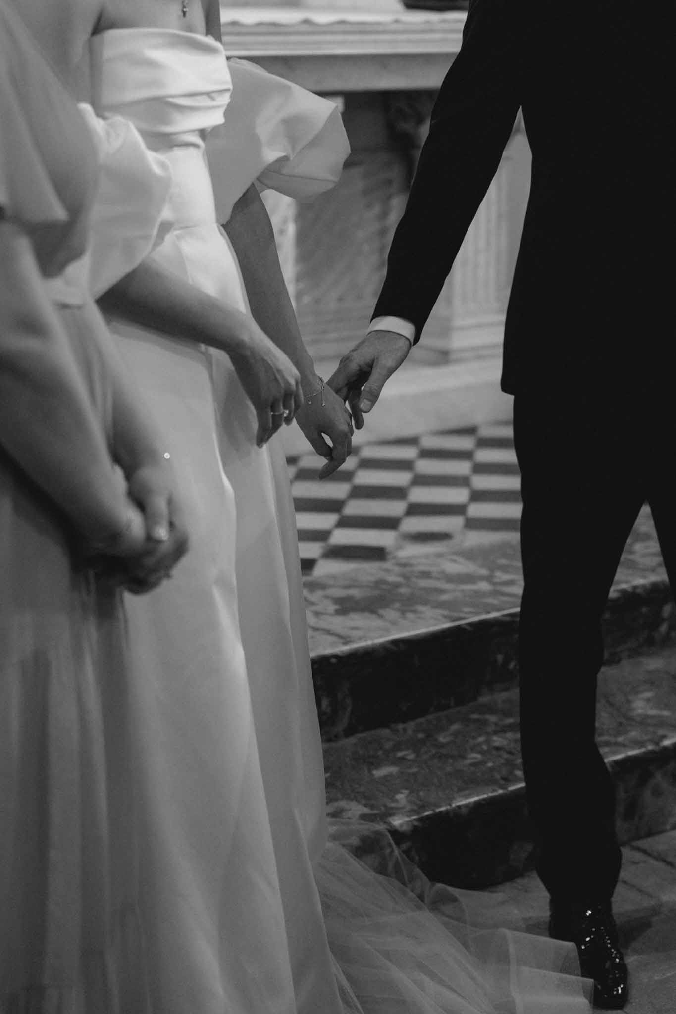 Close-up detail of bride and groom holding hands at Chateau de Martinay photographed by Despinoy