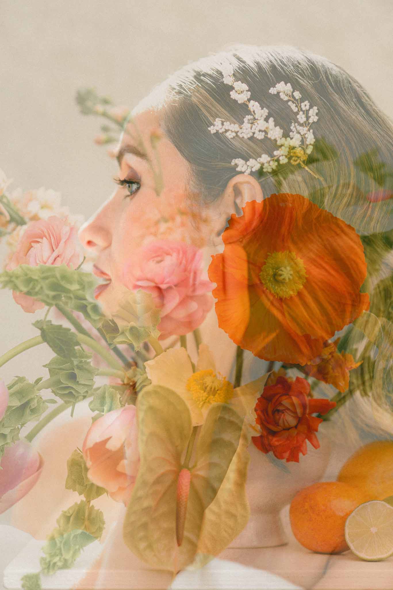 Double-exposure portrait of bride's profile overlaid with orange poppies, ranunculus, and citrus fruits