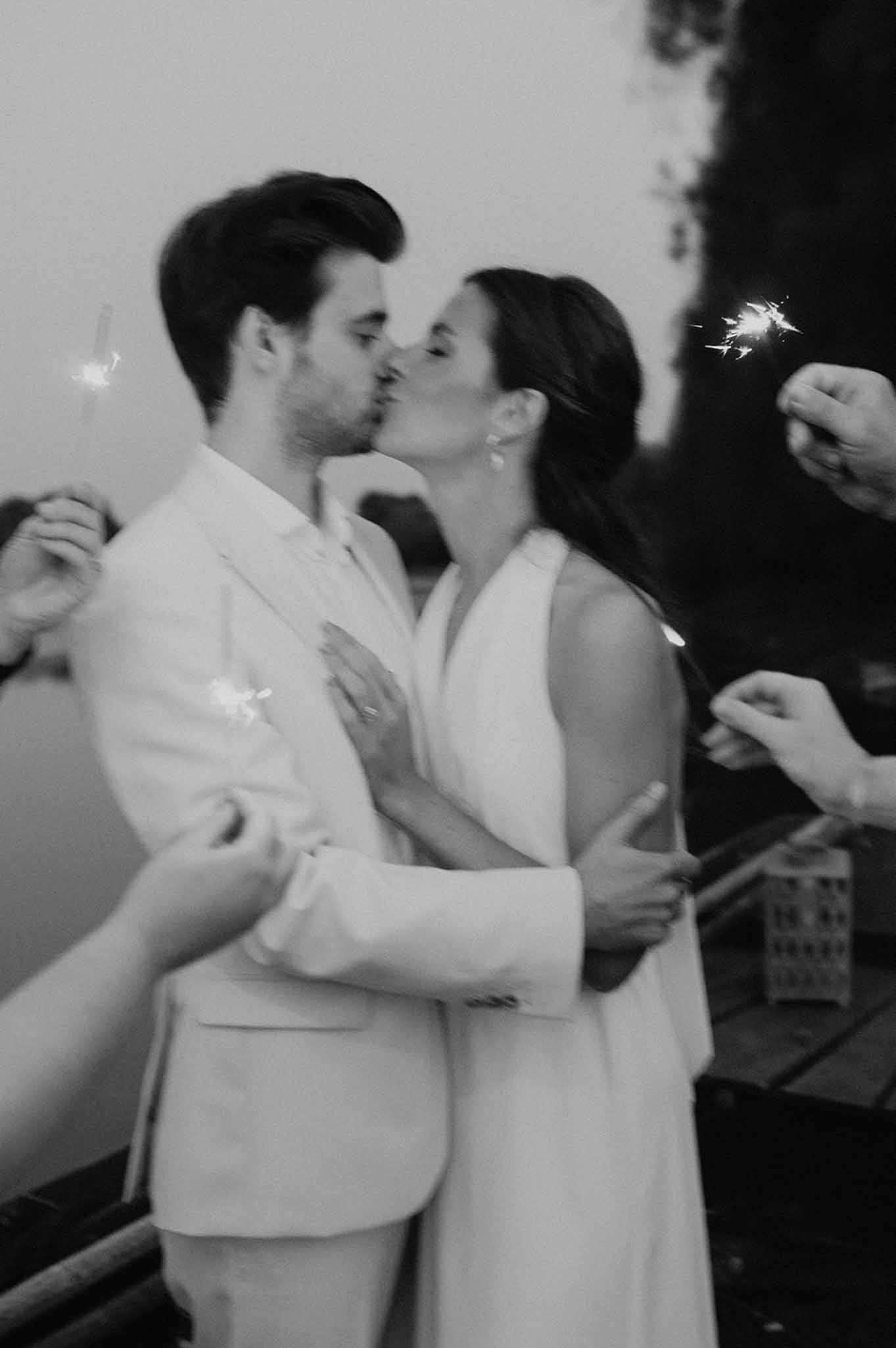 Bride and groom kissing inside a sparkle frame decoration at Loire Valley wedding, black and white