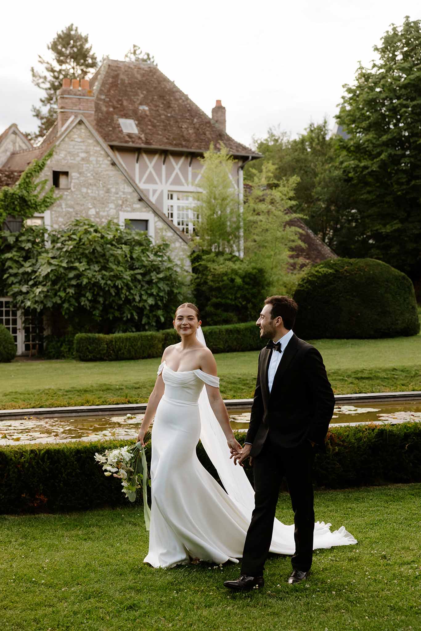 Bride and groom portrait together in front of old house at Dîme de Giverny