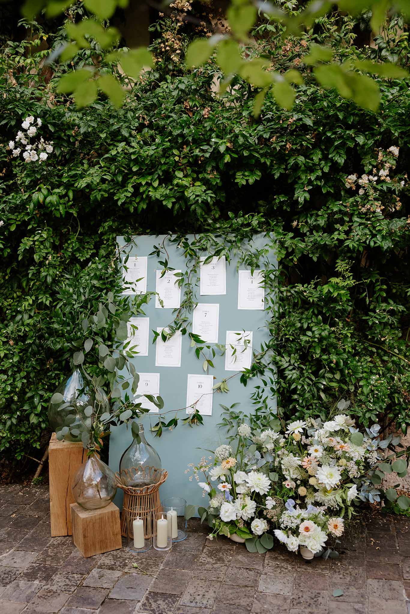 Seating assignment board with blush, blue and greenery styling at Mariage Dime de Giverny