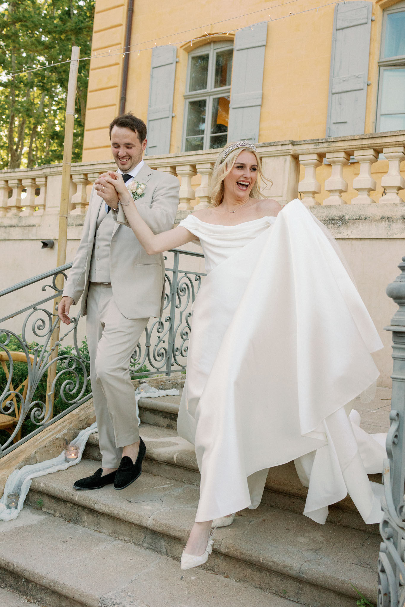 Exterior view of Château de Fonscolombe stone manor house with formal driveway and grounds