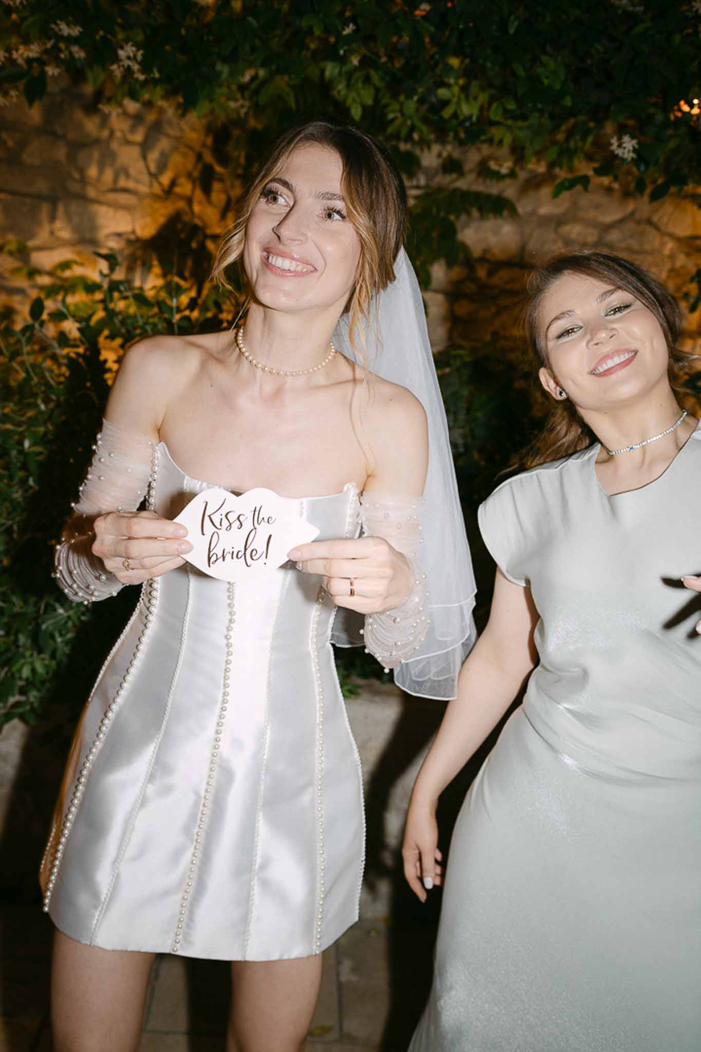 Bride posing with a guest during the wedding reception