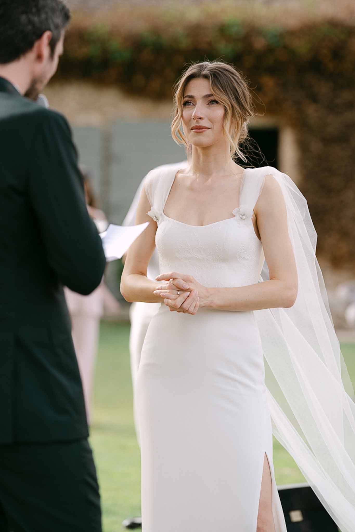 Couple cutting strawberry wedding cake outdoors at Mas de la Rose France reception