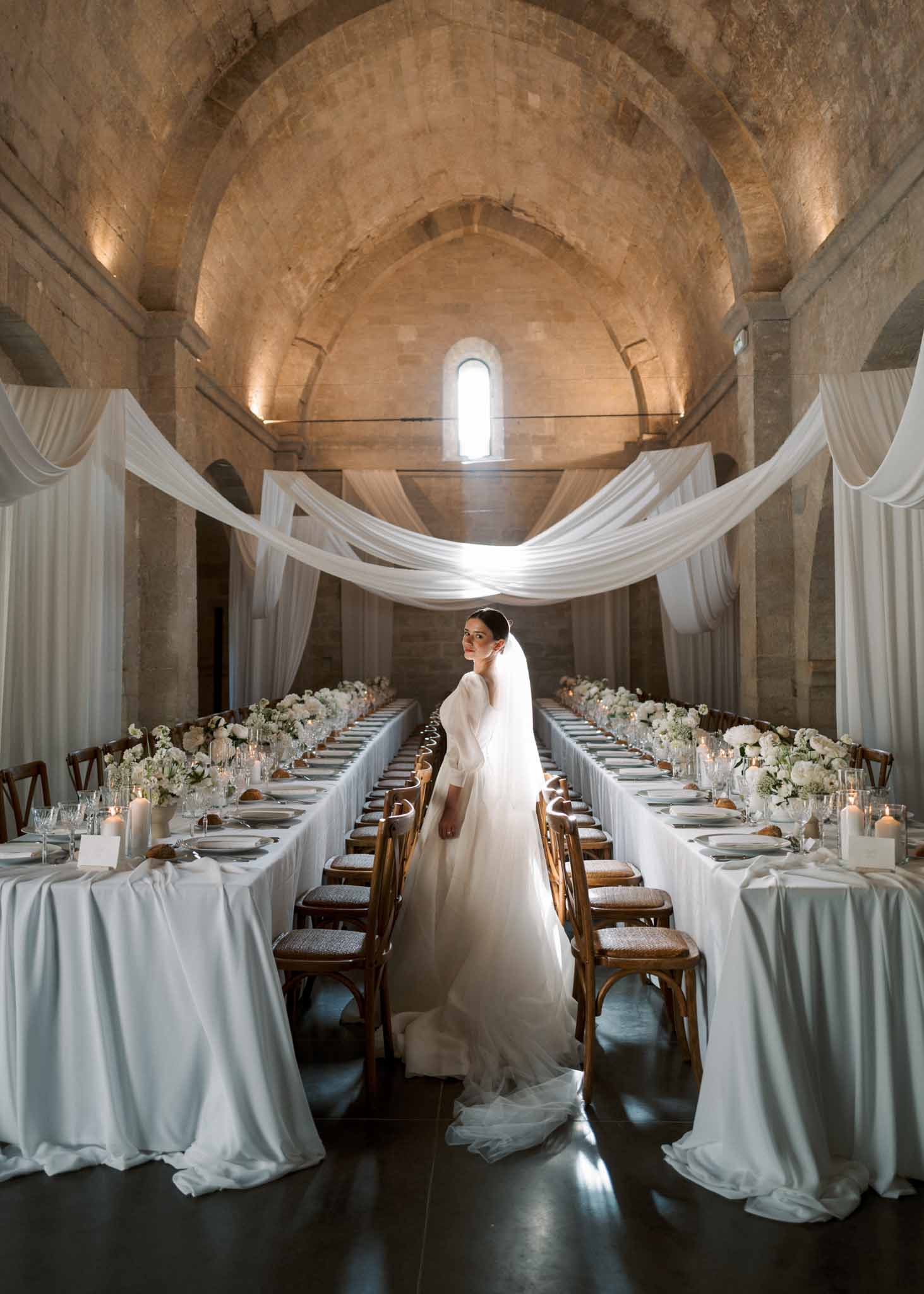 Wedding reception table setting in a garden with white roses