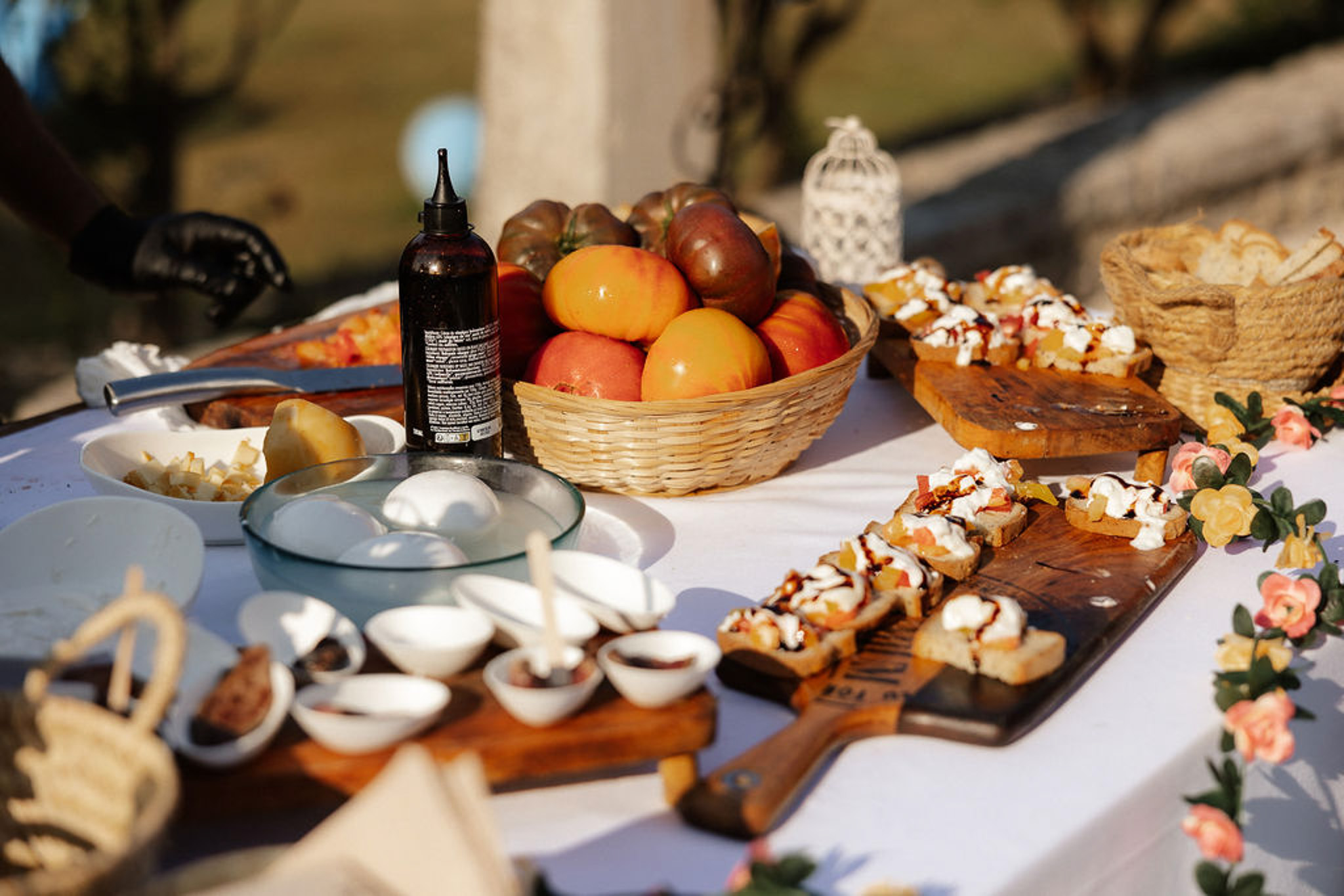 Cocktail hour appetizer display with charcuterie and fresh fruit at outdoor wedding reception