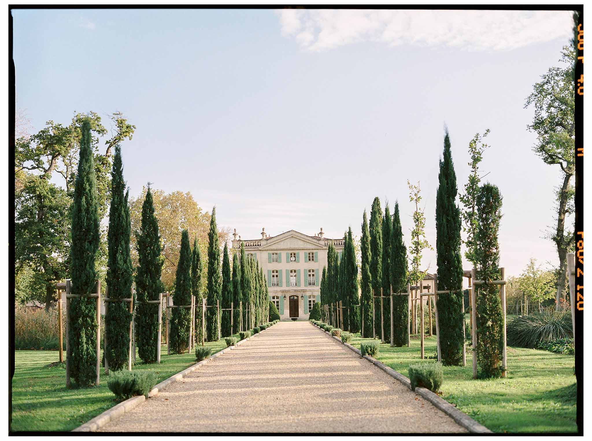 Classical Italian villa with cypress-lined driveway at Mediterranean wedding venue