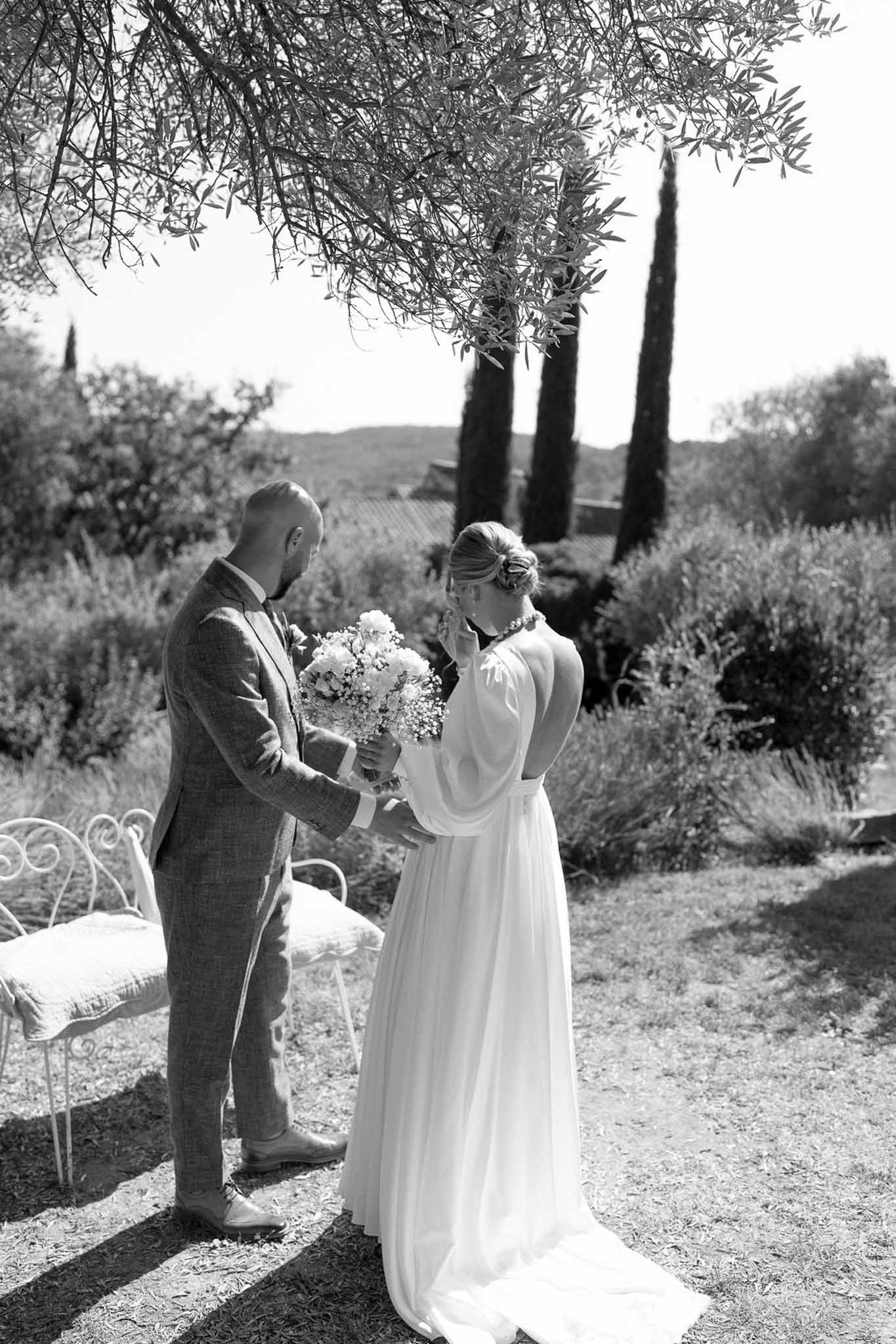 Bride and groom exchanging vows during outdoor ceremony in Mediterranean garden setting
