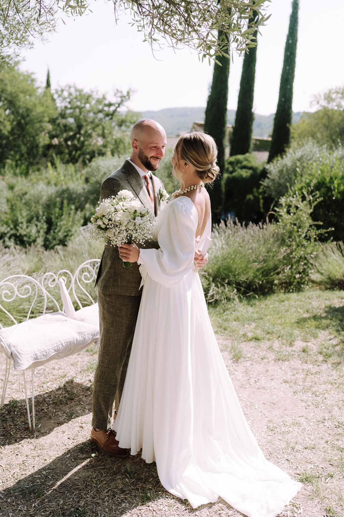 Bride and groom portrait session in Mediterranean garden with cypress trees and rolling hills