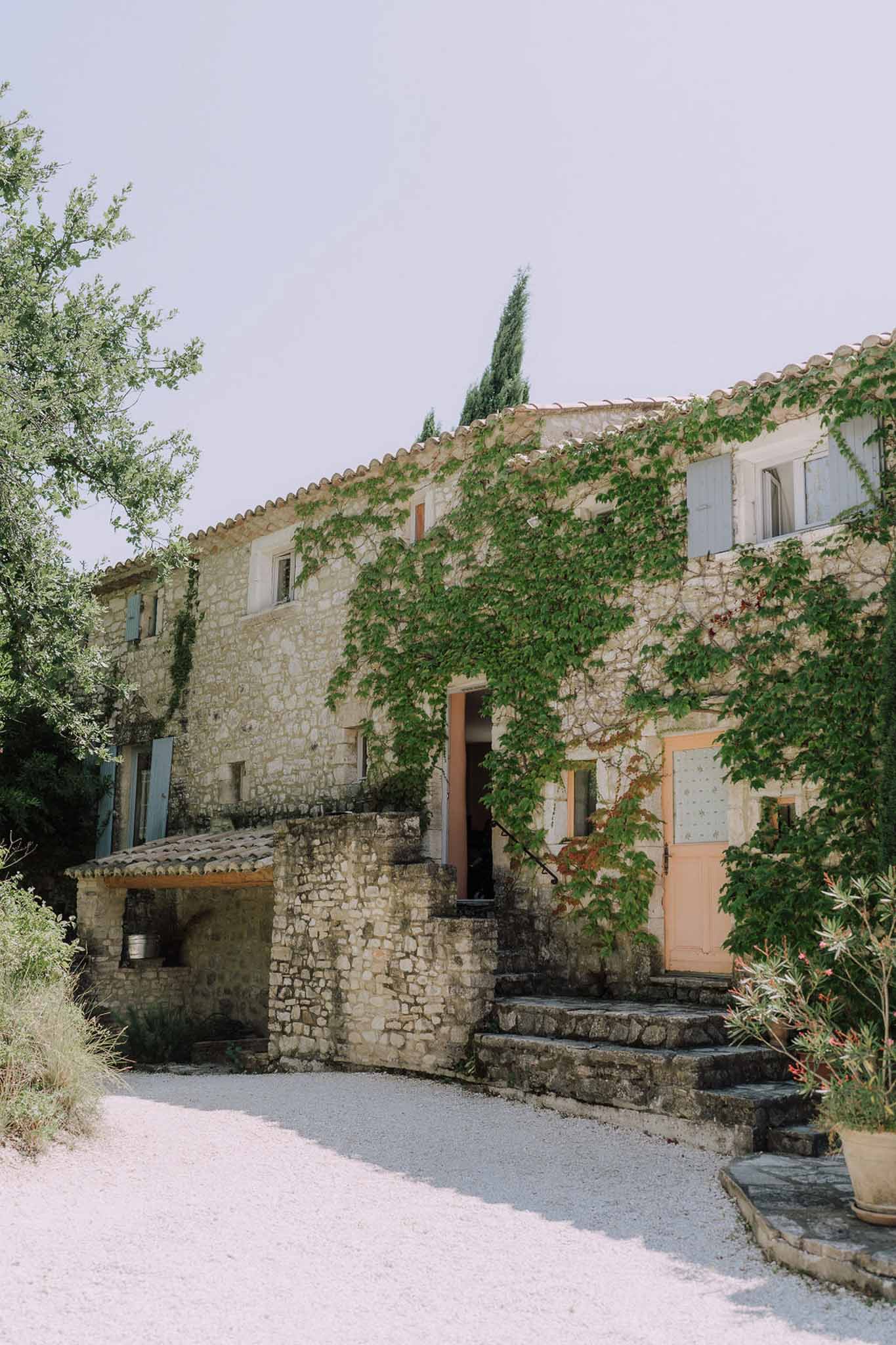 Mediterranean stone venue exterior with ivy-covered walls and terracotta shutters