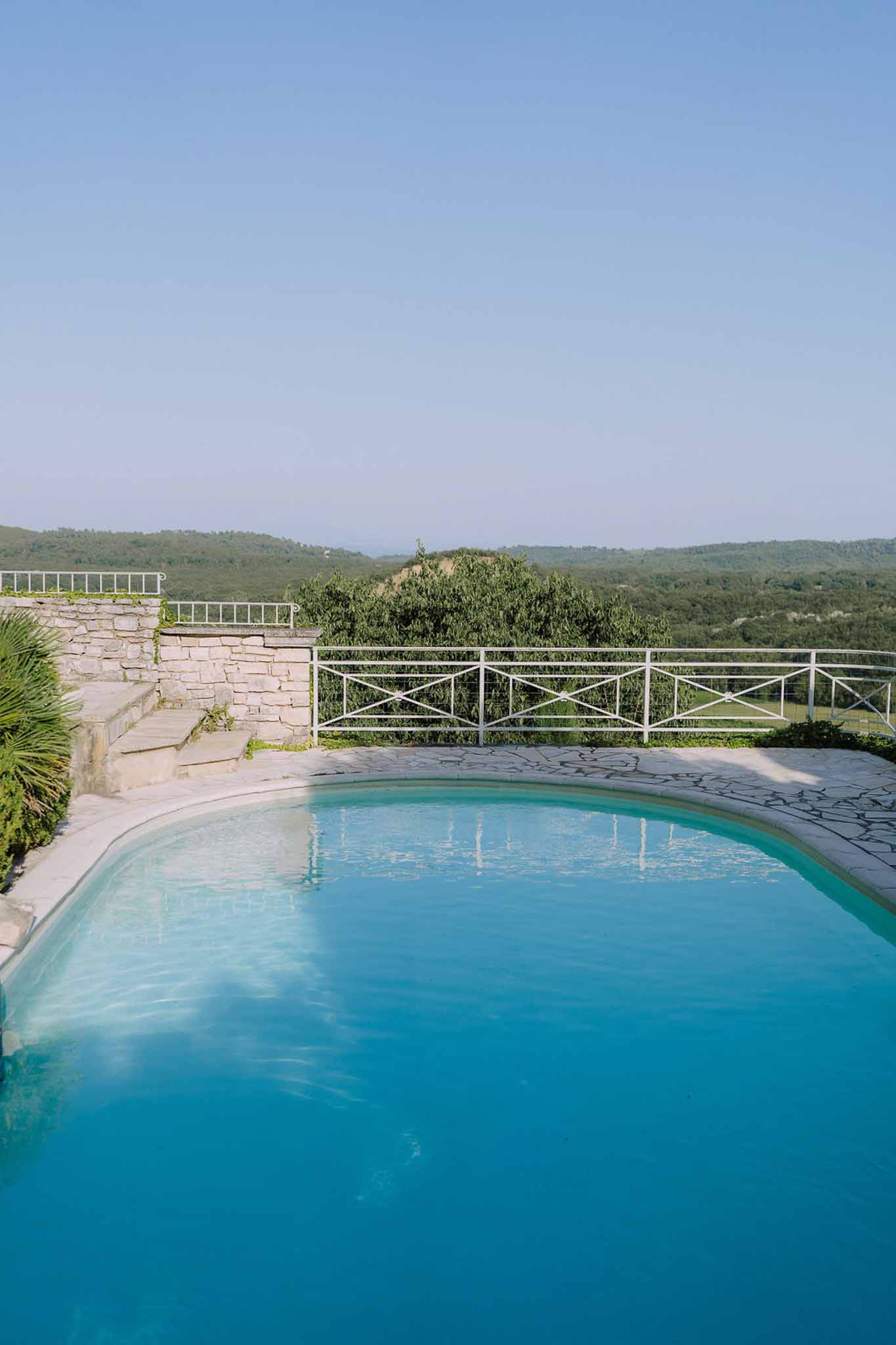 Poolside terrace with swimming pool overlooking rolling hills at wedding venue