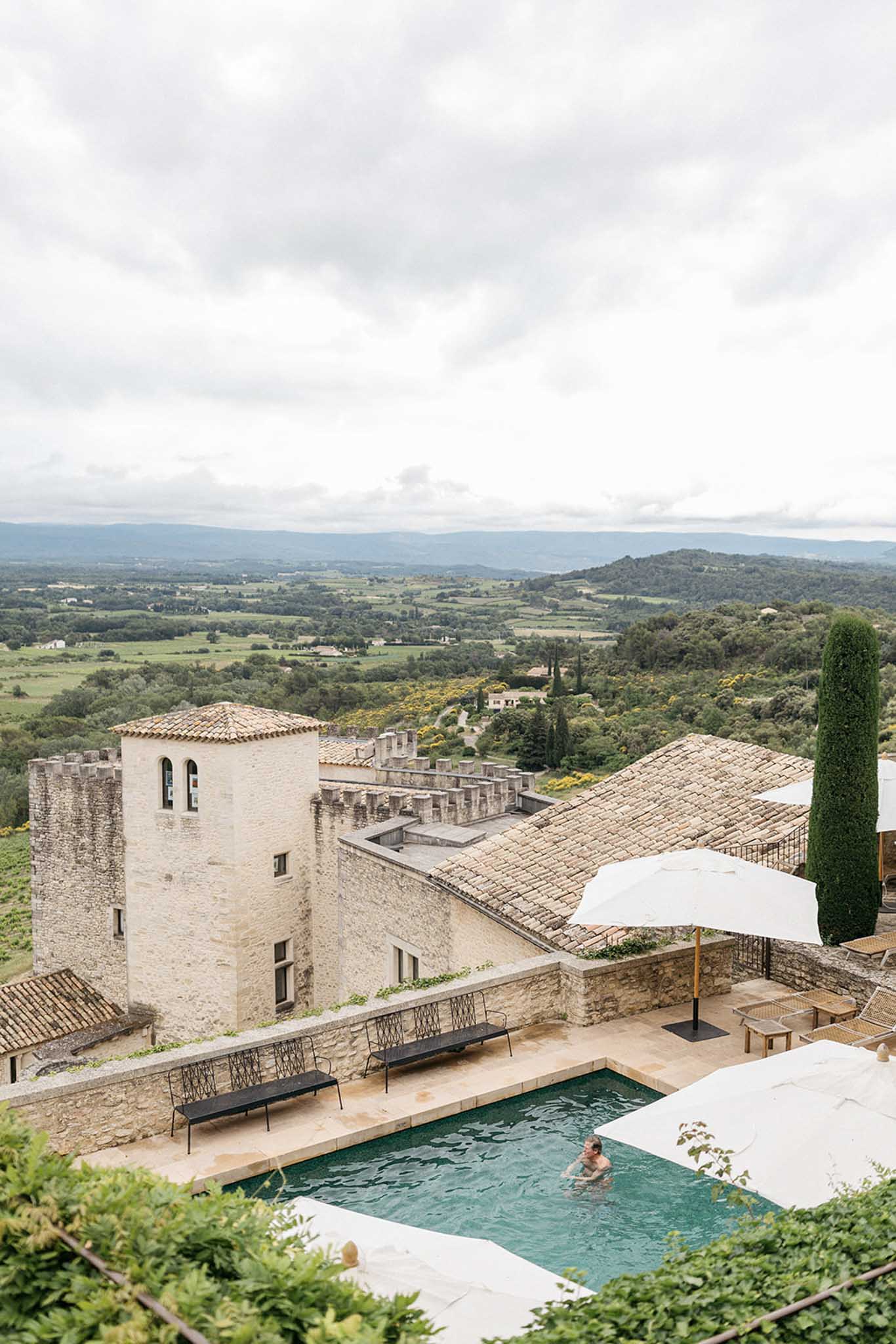 Aerial view of Tuscan stone fortification wedding venue with pool and countryside views