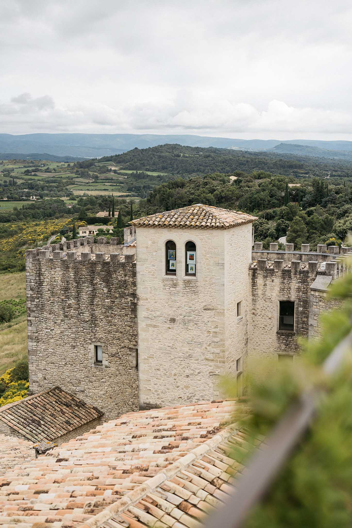 Medieval fortress tower and stone walls in Tuscan hillside landscape